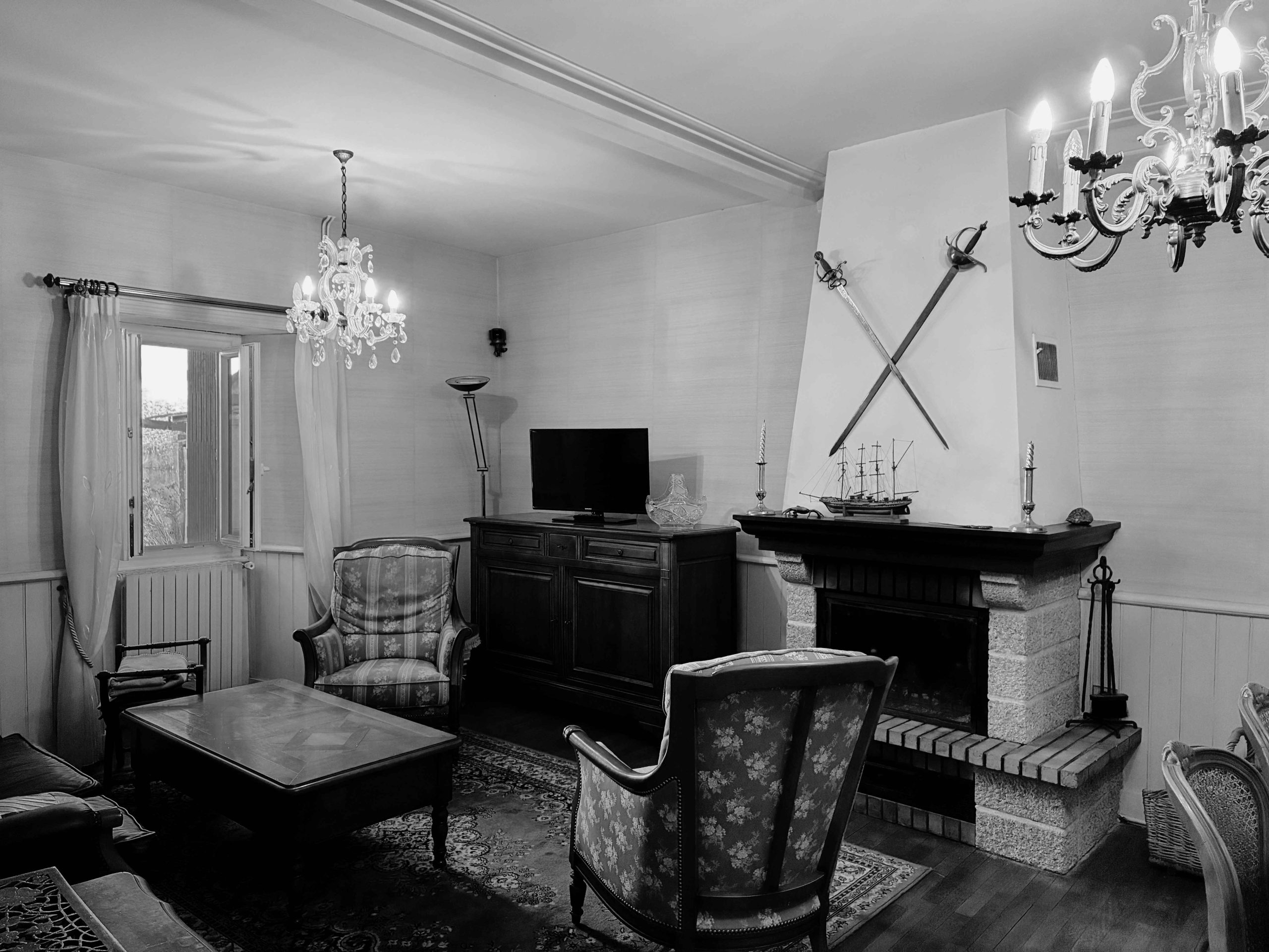 Salon avec cheminée, boiseries et mobilier ancien dans une maison à rénover sur une île du Golfe du Morbihan